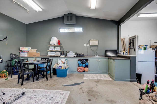 garage featuring freestanding refrigerator and a sink