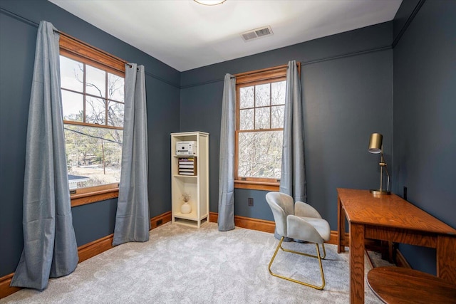 carpeted home office featuring visible vents and baseboards