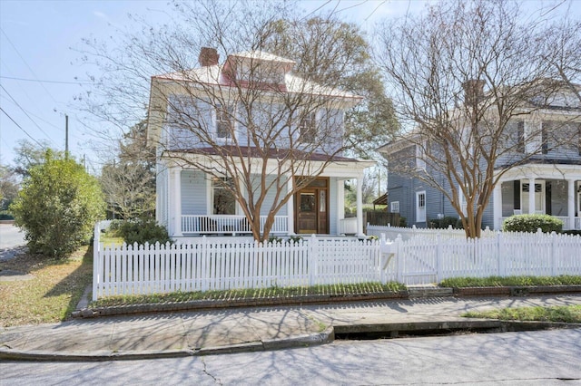 american foursquare style home with a fenced front yard, a porch, and a gate