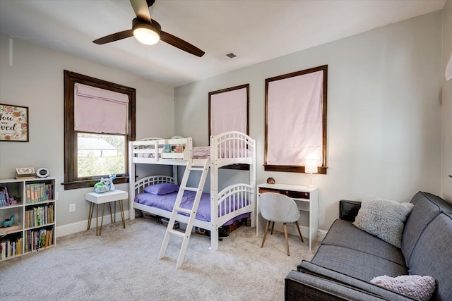 carpeted bedroom featuring visible vents, a ceiling fan, and baseboards