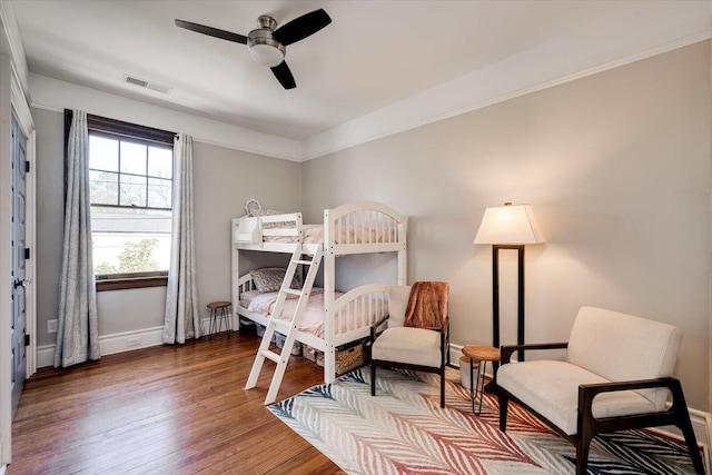 bedroom with visible vents, baseboards, and wood-type flooring