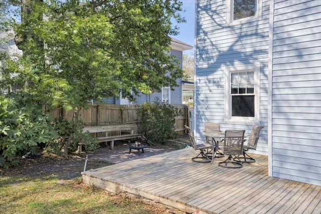 exterior space featuring outdoor dining space, fence, and a wooden deck