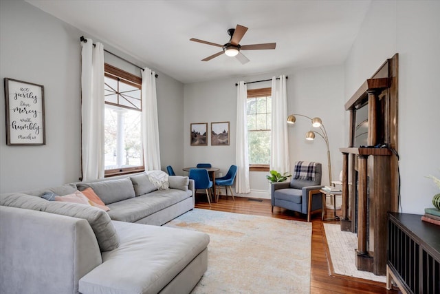 living room featuring wood finished floors and a ceiling fan