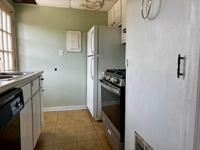 801 Monte Sano Ave, Augusta, GA 30904 - kitchen featuring stainless steel gas range oven, black dishwasher, a sink, tile patterned floors, and baseboards