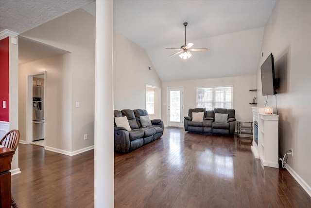 living room with dark hardwood / wood-style flooring, ceiling fan, and lofted ceiling