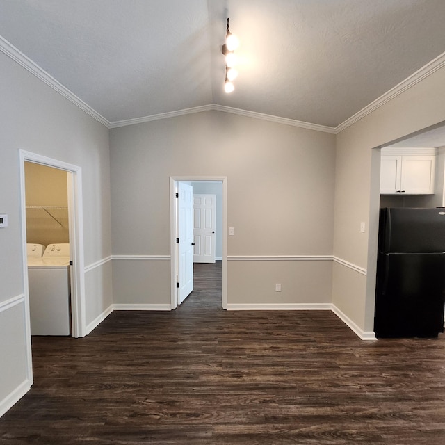 interior space with dark wood-style flooring, baseboards, washer and clothes dryer, and lofted ceiling