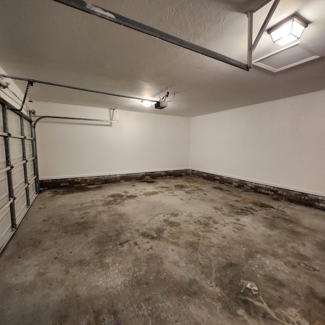 garage featuring baseboards and a garage door opener