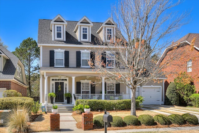 view of front of property featuring roof with shingles, an attached garage, and a porch