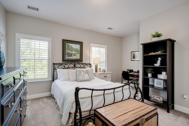 bedroom featuring light colored carpet, baseboards, and visible vents