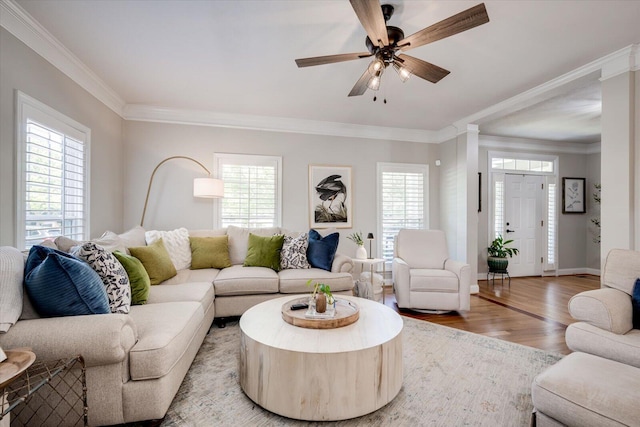 living room with ceiling fan, baseboards, ornamental molding, and wood finished floors
