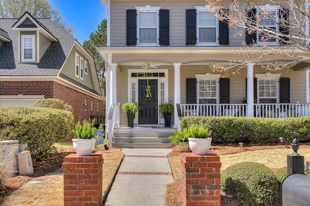 entrance to property with a ceiling fan and covered porch