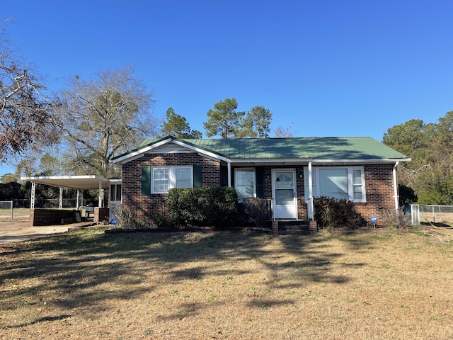 view of front of property with a carport and a front lawn