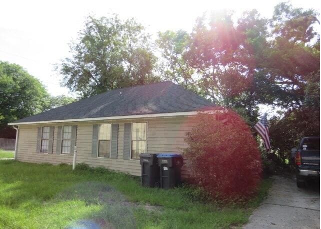 view of side of property with a yard