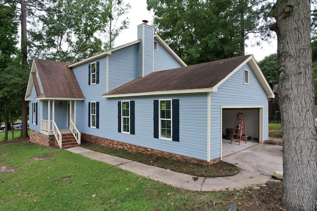 view of front of property featuring covered porch, a garage, and a front yard