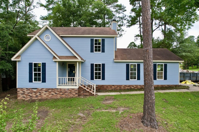 colonial home featuring a front lawn