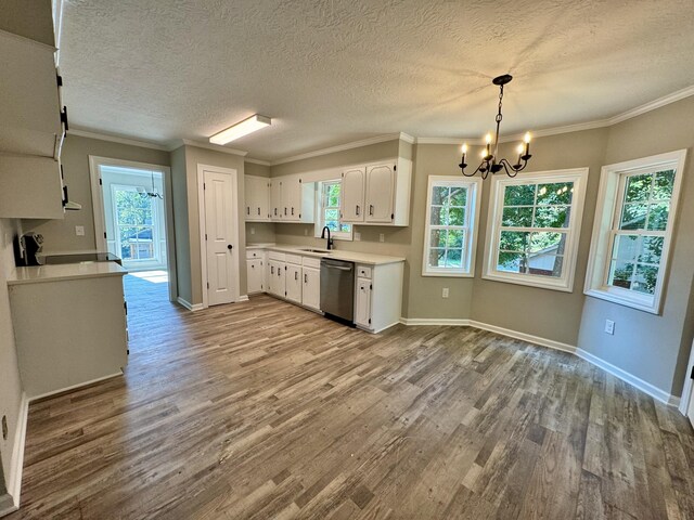 kitchen with pendant lighting, an inviting chandelier, white cabinets, sink, and stainless steel dishwasher