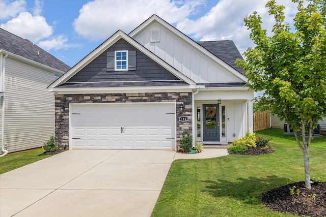 craftsman inspired home with a garage and a front lawn