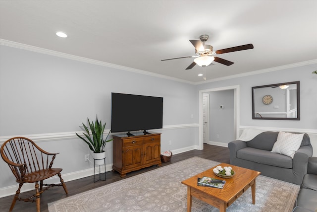 living room with ceiling fan, ornamental molding, and dark wood-type flooring