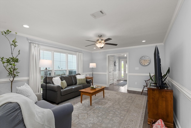 living room featuring ceiling fan, dark hardwood / wood-style flooring, and ornamental molding