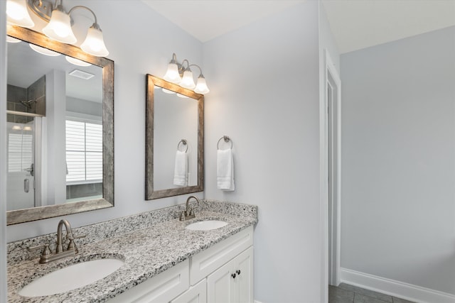 bathroom with tile patterned flooring, vanity, and a shower with shower door