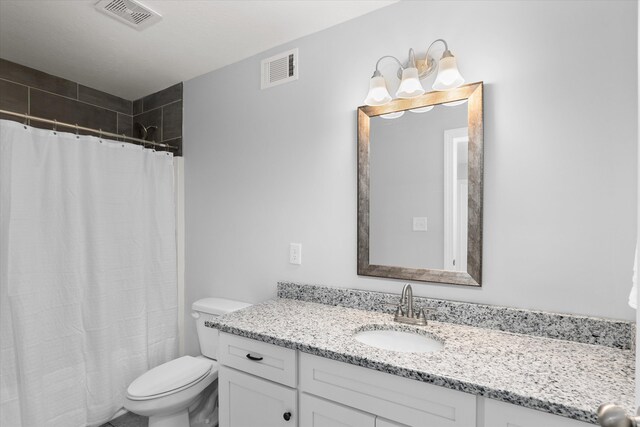 bathroom featuring a shower with curtain, vanity, and toilet