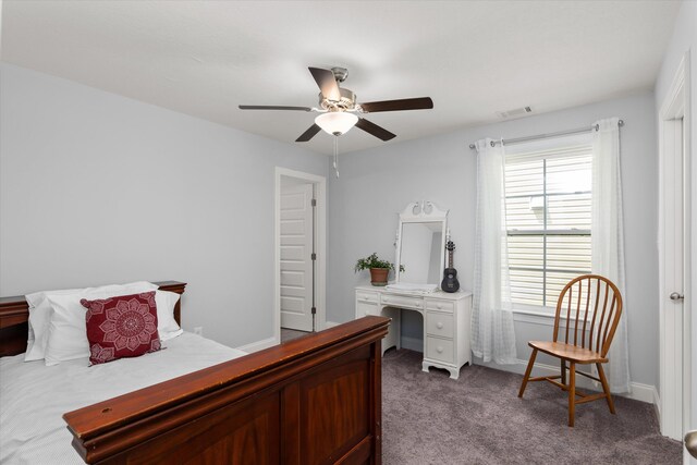 carpeted bedroom with multiple windows and ceiling fan