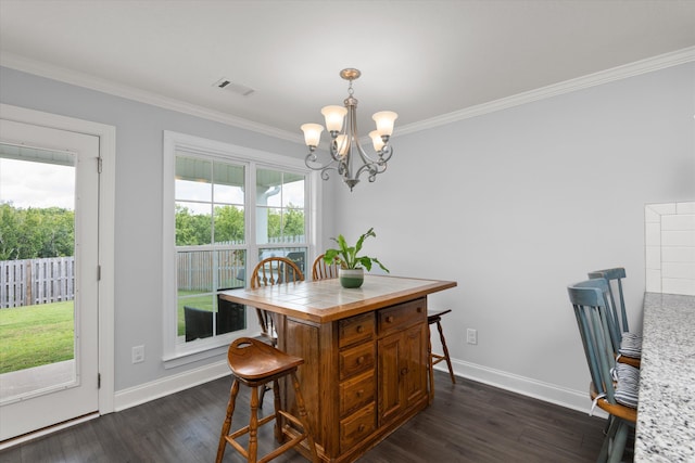 dining room featuring a chandelier, dark hardwood / wood-style floors, and ornamental molding