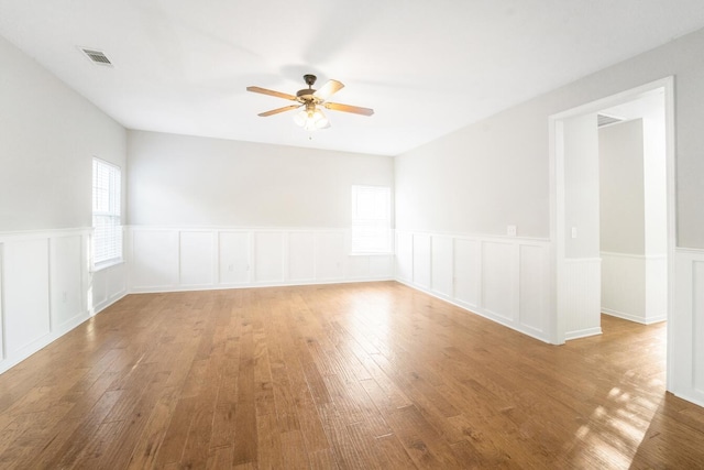 unfurnished room featuring hardwood / wood-style floors and ceiling fan