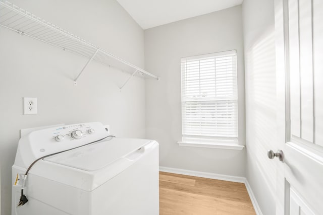 washroom with light hardwood / wood-style flooring and washer and clothes dryer