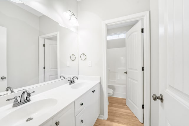 bathroom featuring vanity, toilet, and wood-type flooring