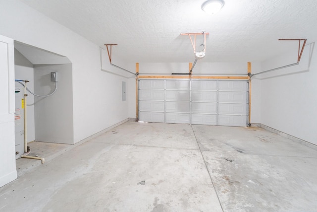 garage featuring electric panel and water heater