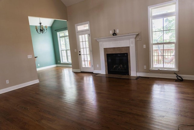 1212 Sumter Landing Ln, Evans, GA 30809 - unfurnished living room with vaulted ceiling, a chandelier, dark wood finished floors, and a high end fireplace
