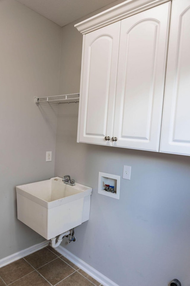 1212 Sumter Landing Ln, Evans, GA 30809 - laundry area featuring hookup for a washing machine, dark tile patterned flooring, and cabinet space