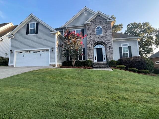 1212 Sumter Landing Ln, Evans, GA 30809 - traditional-style home with concrete driveway, a front yard, an attached garage, stone siding, and entry steps