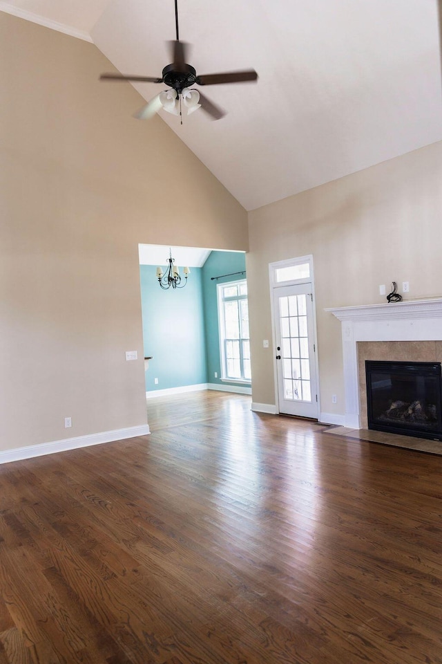 1212 Sumter Landing Ln, Evans, GA 30809 - unfurnished living room featuring a high end fireplace, high vaulted ceiling, a chandelier, dark wood-style floors, and a ceiling fan