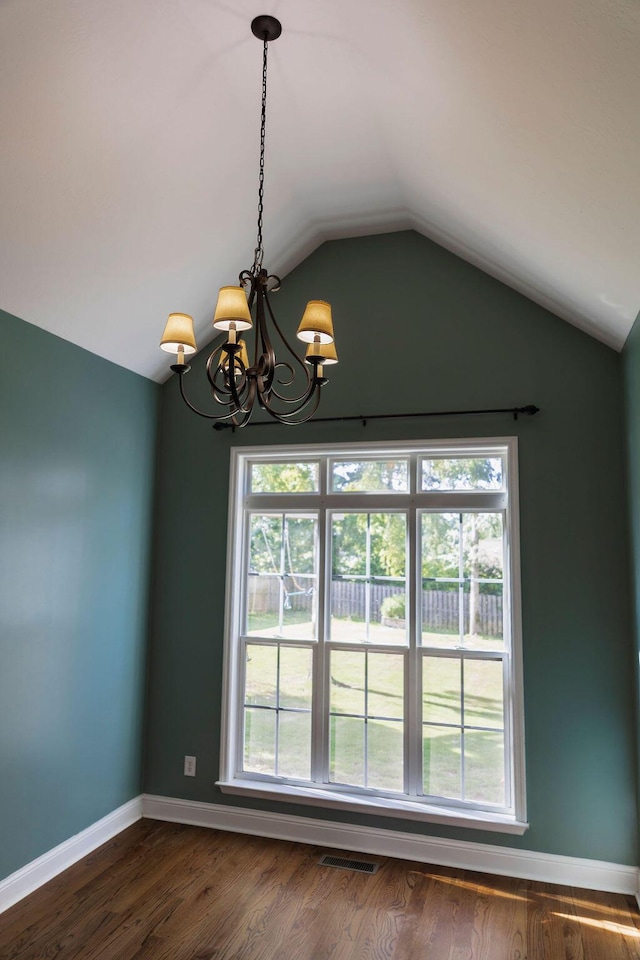 1212 Sumter Landing Ln, Evans, GA 30809 - unfurnished room with a chandelier, lofted ceiling, plenty of natural light, and dark wood-style flooring