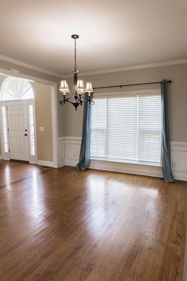 1212 Sumter Landing Ln, Evans, GA 30809 - entrance foyer featuring a chandelier, ornamental molding, wainscoting, dark wood-type flooring, and a decorative wall