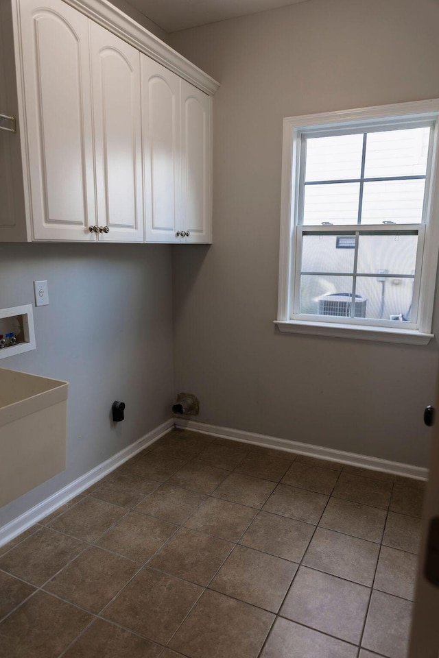 1212 Sumter Landing Ln, Evans, GA 30809 - washroom with hookup for a washing machine, dark tile patterned flooring, and cabinet space