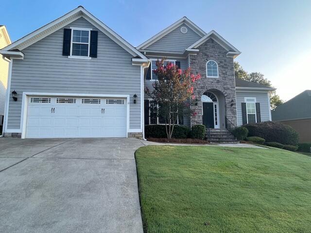 1212 Sumter Landing Ln, Evans, GA 30809 - traditional home with driveway, stone siding, a front lawn, and a garage