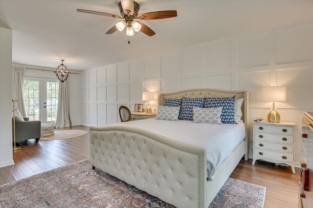 508 Scotts Way, Augusta, GA 30909 - bedroom with a decorative wall, wood finished floors, french doors, access to exterior, and a chandelier