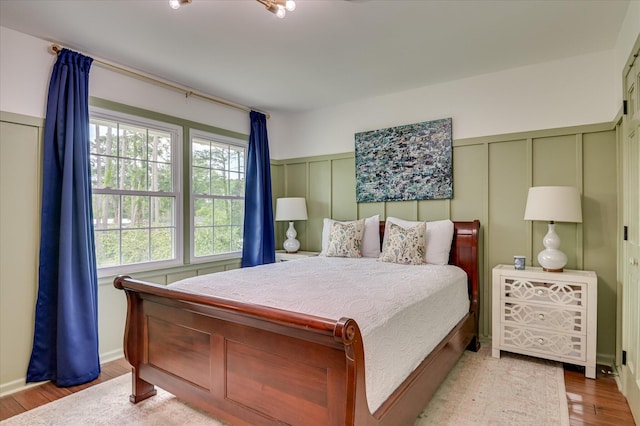 508 Scotts Way, Augusta, GA 30909 - bedroom featuring a decorative wall, wood finished floors, and wainscoting
