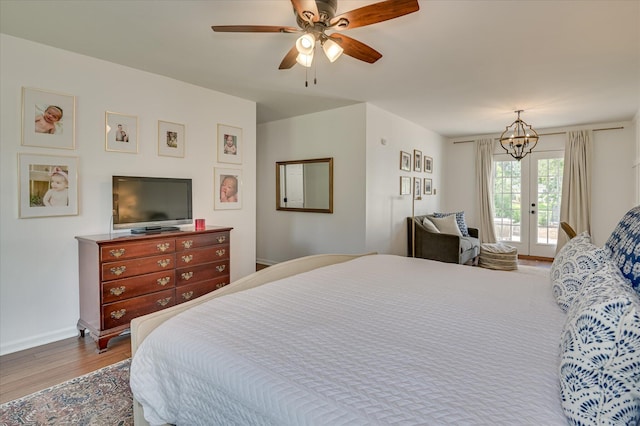 508 Scotts Way, Augusta, GA 30909 - bedroom featuring access to outside, wood finished floors, a ceiling fan, and a chandelier
