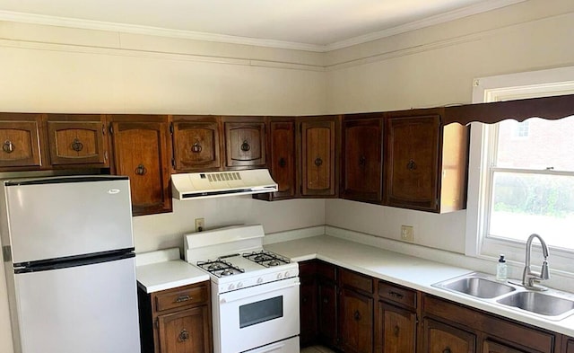 1424 Arsenal Ave, Augusta, GA 30904 - kitchen featuring freestanding refrigerator, under cabinet range hood, gas range gas stove, light countertops, and crown molding