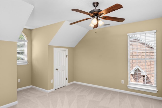 additional living space featuring ceiling fan, light carpet, and vaulted ceiling