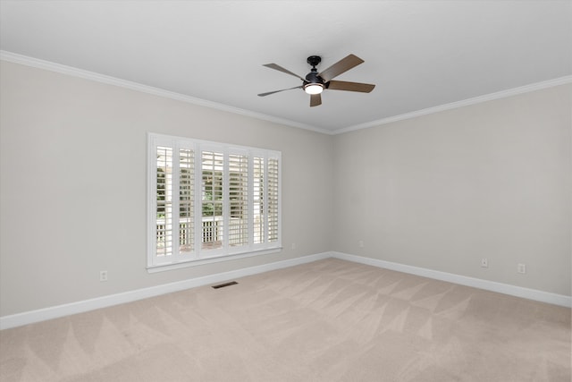 carpeted empty room with ceiling fan and ornamental molding