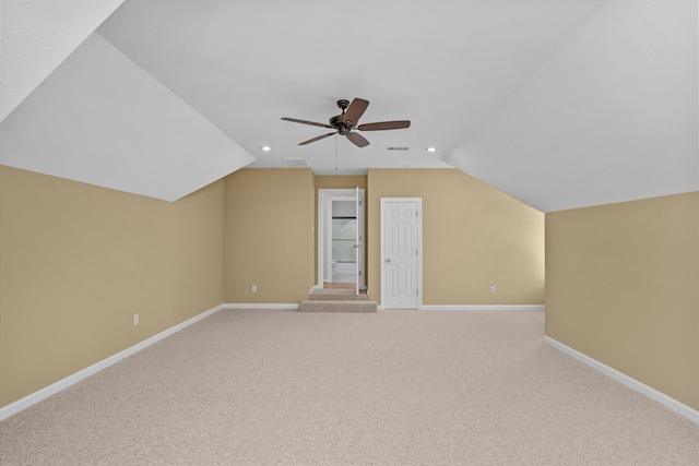 additional living space featuring ceiling fan, lofted ceiling, and light carpet