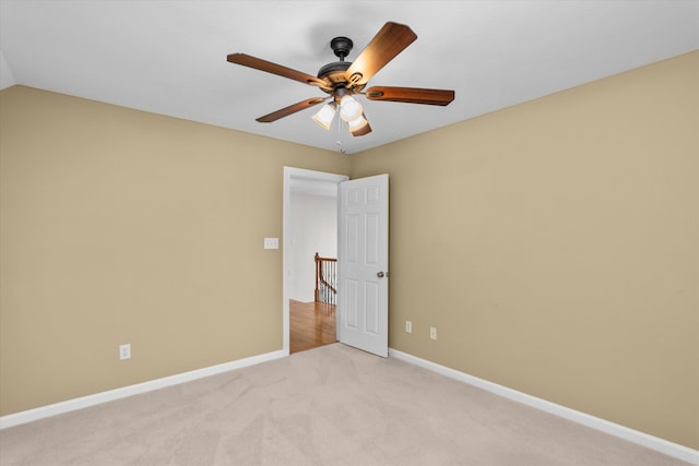 spare room with light carpet and ceiling fan