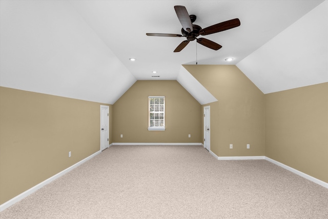 additional living space featuring ceiling fan, light carpet, and vaulted ceiling