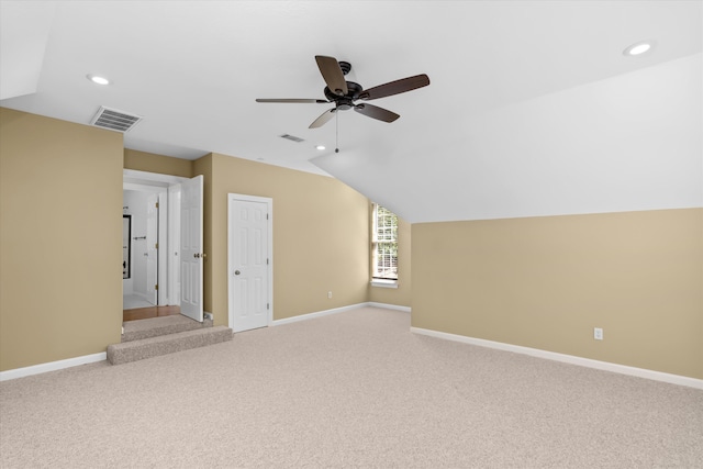 unfurnished living room featuring ceiling fan, light carpet, and lofted ceiling