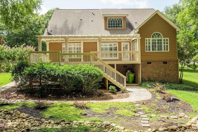 rear view of property with a wooden deck